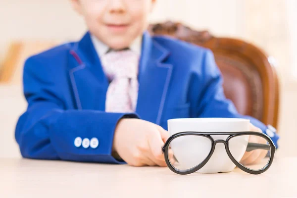 Schoolboy with cup and glasses. — Stock Photo, Image