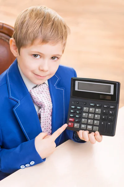 Little boy pointing at the calculator. — Stock Photo, Image