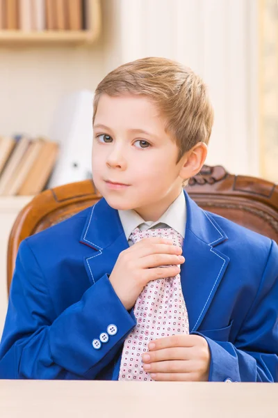 Little boy adjusting big tie. — Stock Photo, Image