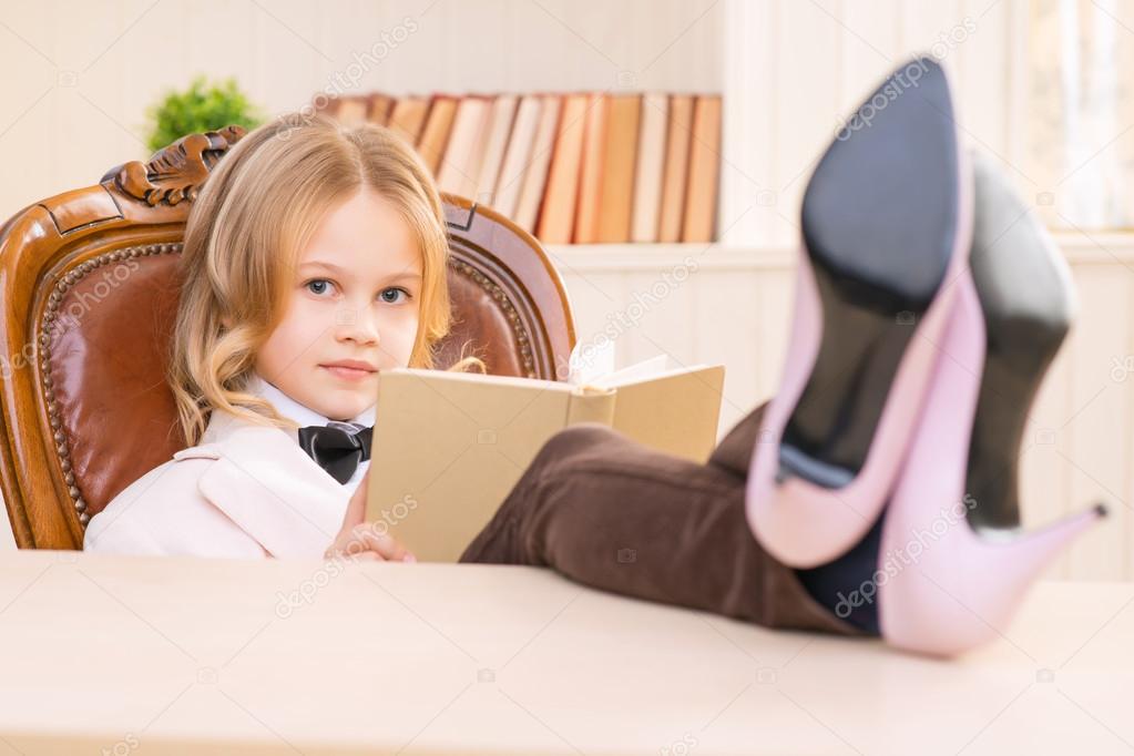 Lovely girl is reading a book.