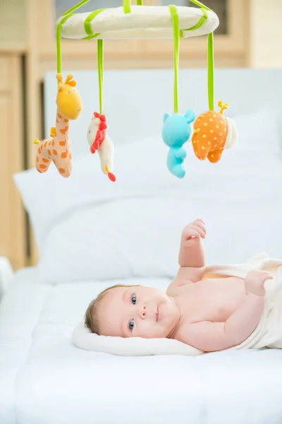 Cute infant lying in bed — Stock Photo, Image