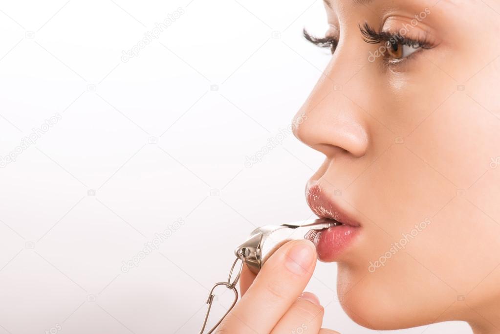 Young attractive girl blowing a whistle.