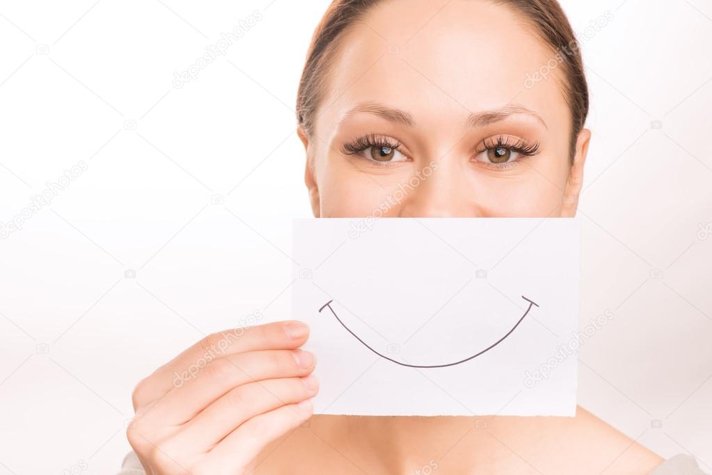 Young girl with smiley paper.