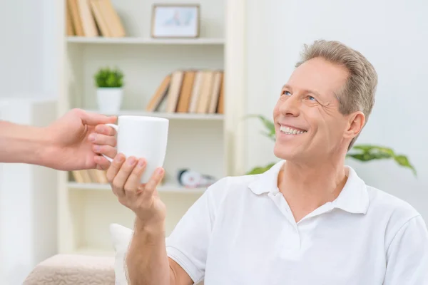 Senior man holding cup of  tea — Stok fotoğraf