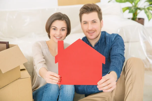 Couple with red little house in hands — Stock Photo, Image