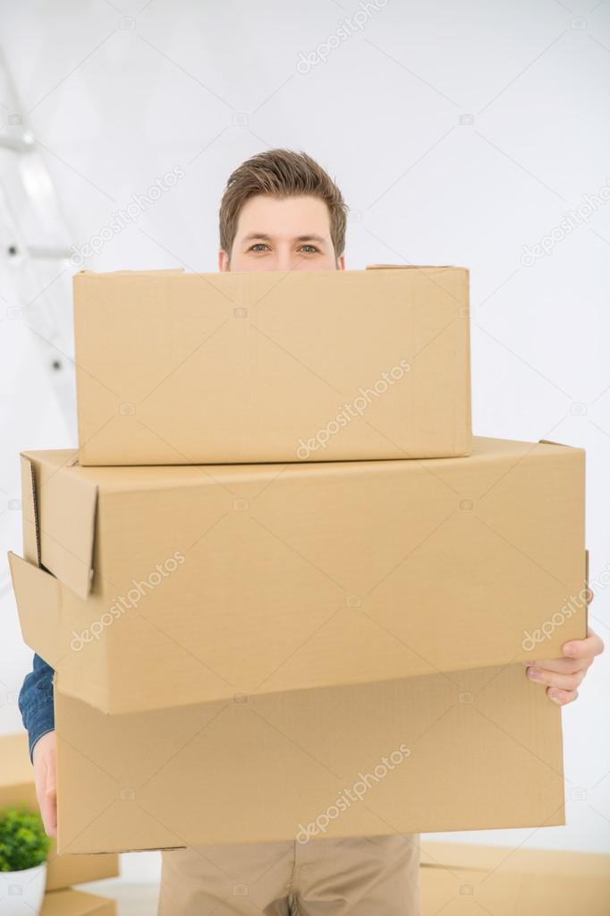 Pleasant man holding boxes