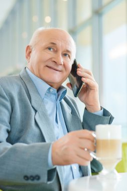 Old man making a call.