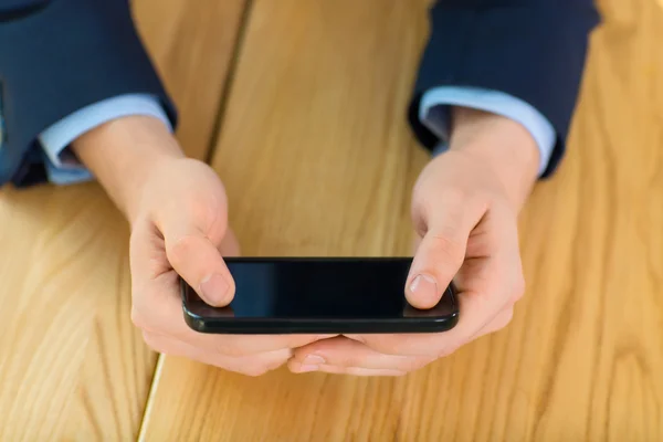 Shot of smartphone holding by male. — Stockfoto