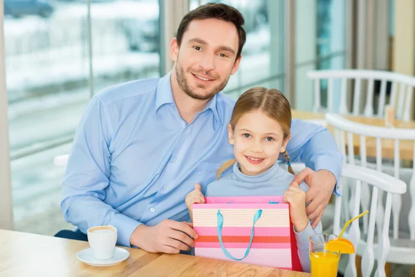 Joyful father sitting and hugging  kid — Stock Photo, Image