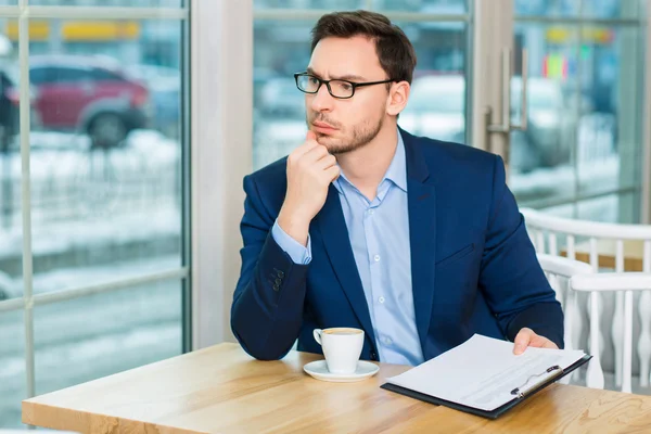 Man  with documents and coffee. — Stock Photo, Image
