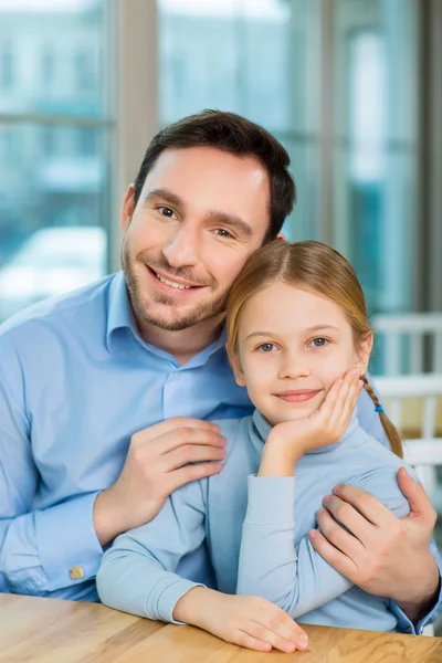Father is sitting with cute daughter — Stock Photo, Image