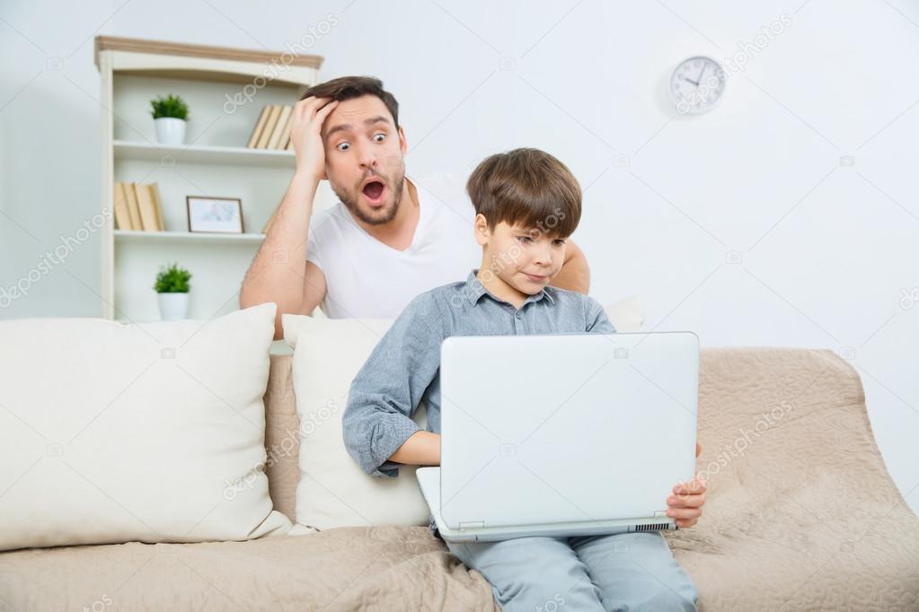 father staring at laptop