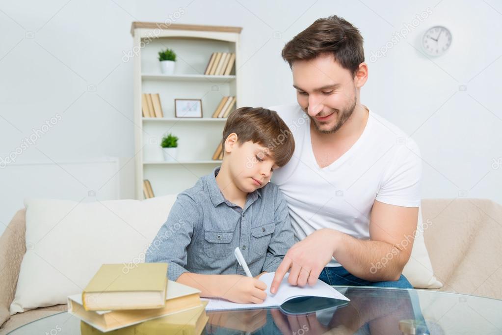 father is helping son to solve homework
