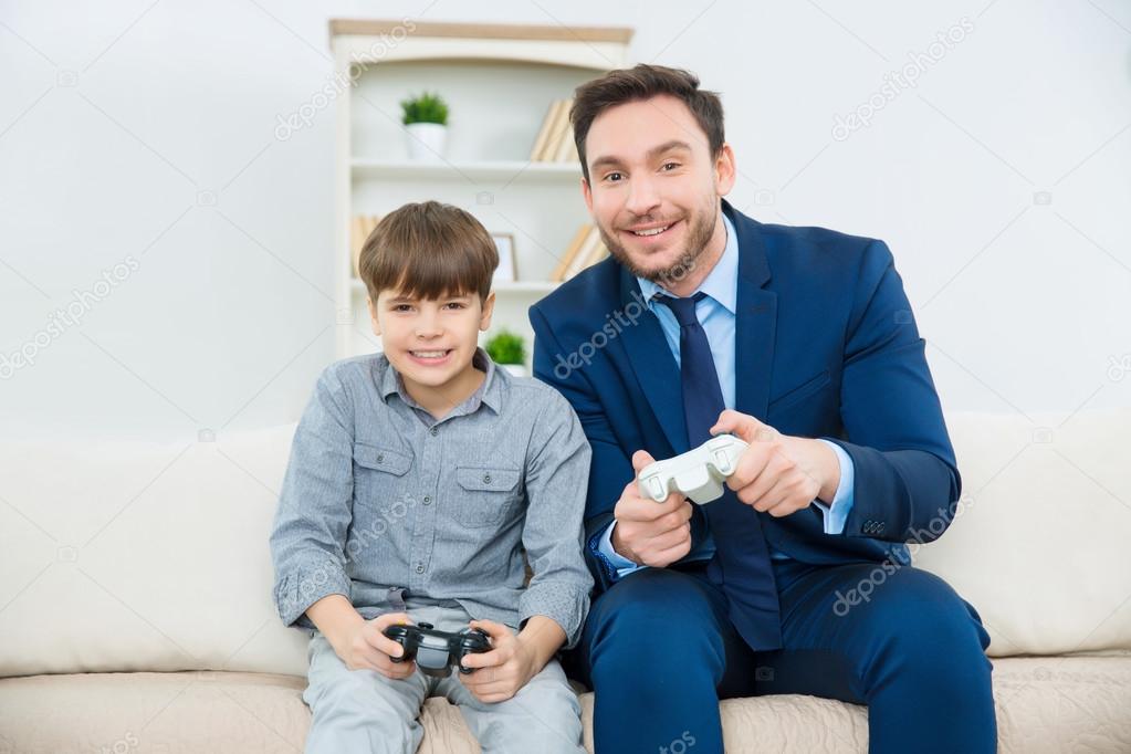 father  playing video games with  son