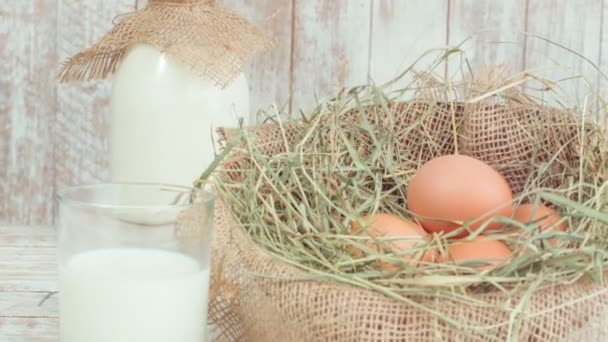 Milk and eggs in straw nest. — Stock Video