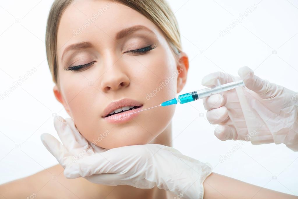 Professional cosmetologist making injections