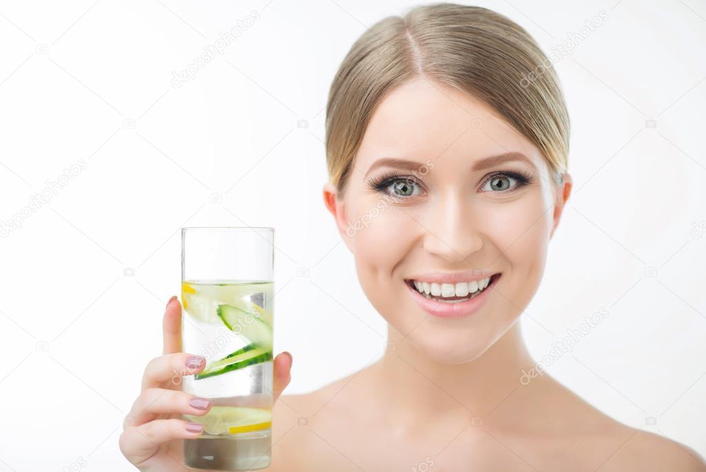 Pleasant woman holding glass of water