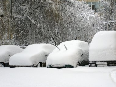 Cars covered with snow. Heavy snowfall in the city. Street of the city unit tunes snow.