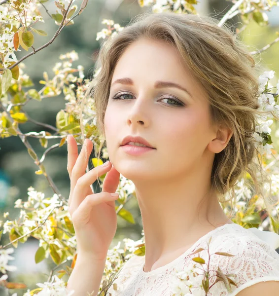 Hermosa joven con flores en el pelo — Foto de Stock