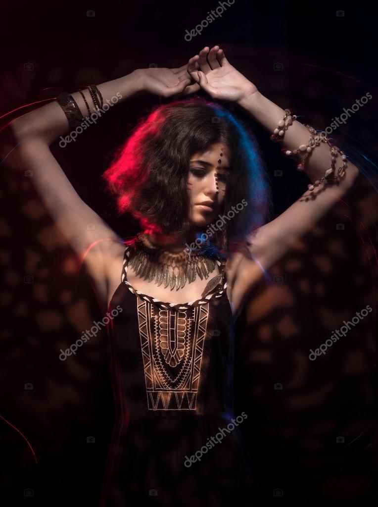 Art portrait of beautiful young woman with tribal styling. Mixed light Stock Photo by ©jutar 121594912