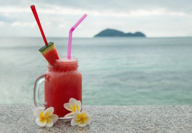 Tropikal adada deniz manzaralı taze meyve kokteylleri.
