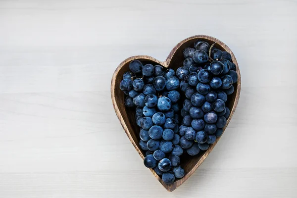 Uvas em forma de coração placa de madeira — Fotografia de Stock