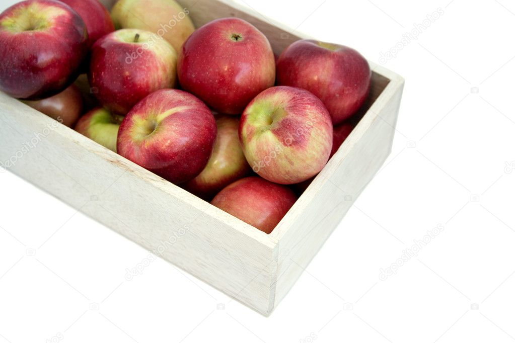 Apples in the wooden box on the table, close up