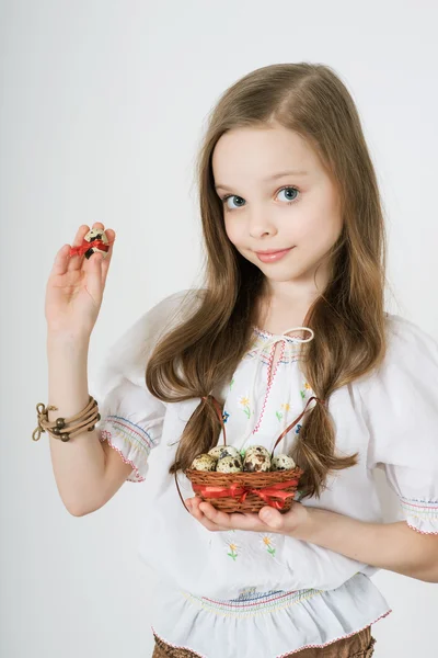 Girl with basket full of easter eggs — Stock Photo, Image