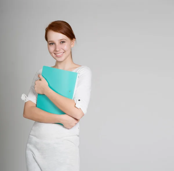Student in white dress with green folder — Stock Photo, Image