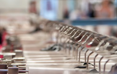 Giysiler bir mağazanın rafında asılı. 