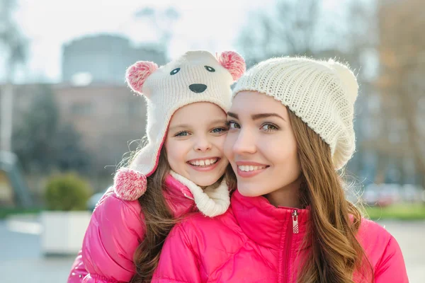 Two girls walking  in the city.