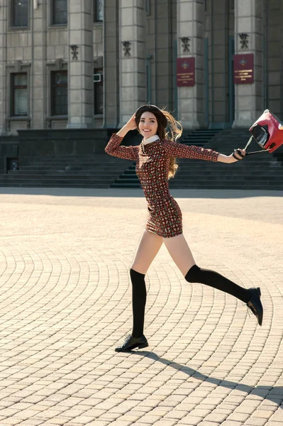 Beautiful brunette girl in stylish dress jumps — Stock Photo, Image