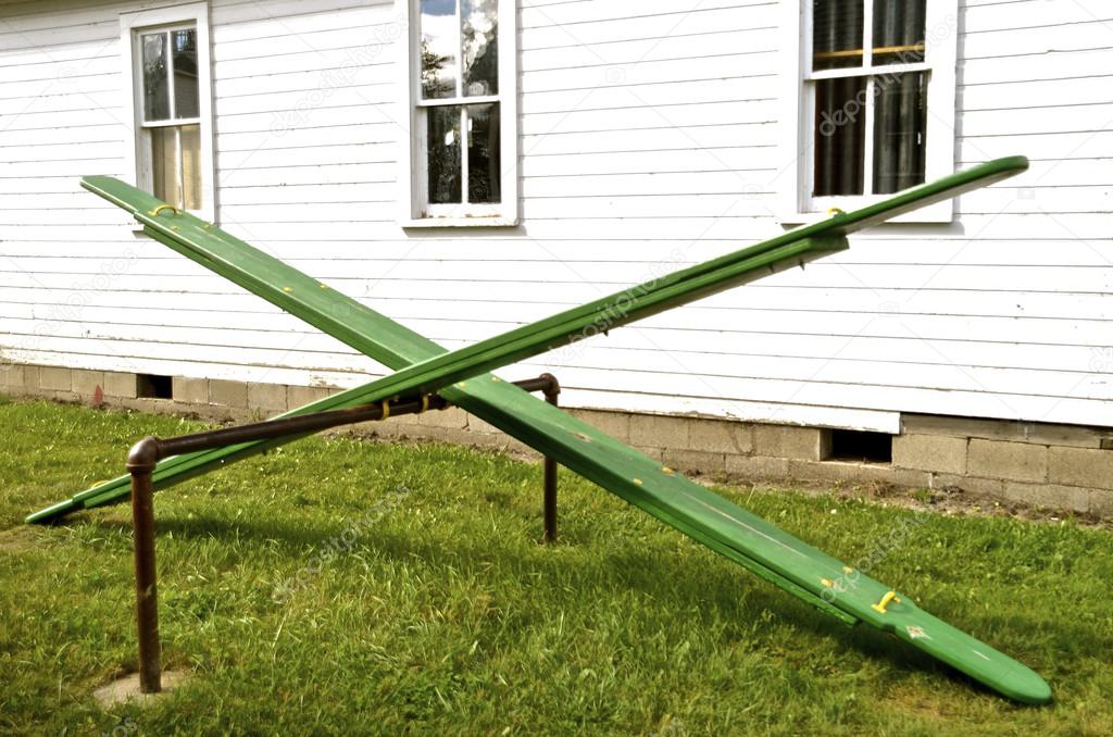 Identical green old teeter totters Stock Photo by ©fiskness 105823776