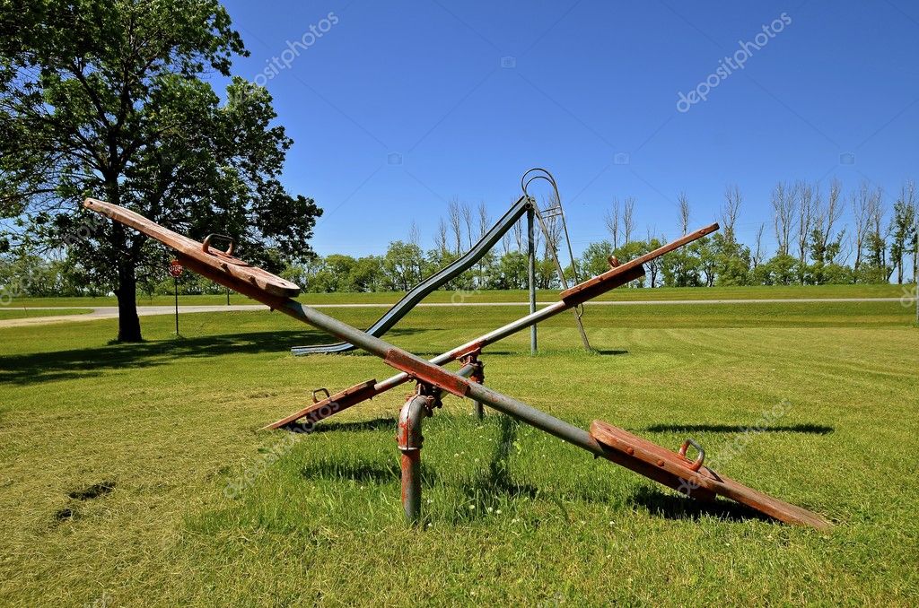 Old teeter totters and slippery slide Stock Photo by ©fiskness 114144258
