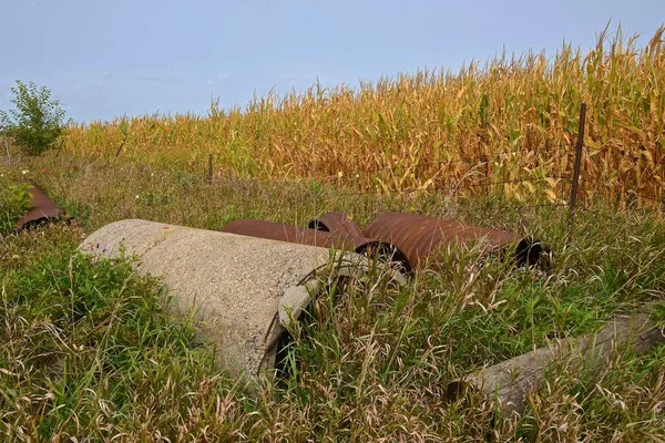 Discarded Old Concrete Metal Culvert Sewage Sections Stored Next Cornfield — Stock Photo, Image