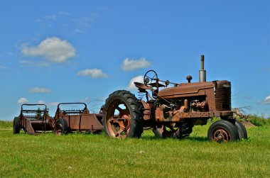 Tractor and two manure spreaders clipart