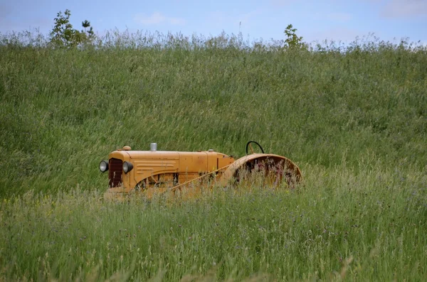 Tractor amarillo en hierba larga — Foto de Stock