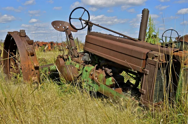 Rozsdás régi traktor egy roncstelep — Stock Fotó