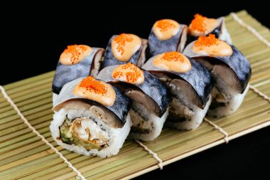 Suşi ve soya sosu kasede ve tahta çubuklar gri tahta bir masada. Japon yemeği. Suşi seti. Çeşitli ekmekler. Menü.