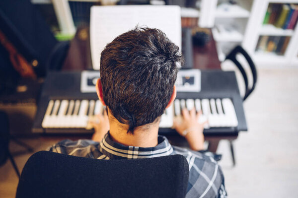 Pianist playing the piano seen from above.Music love.Enjoying at home