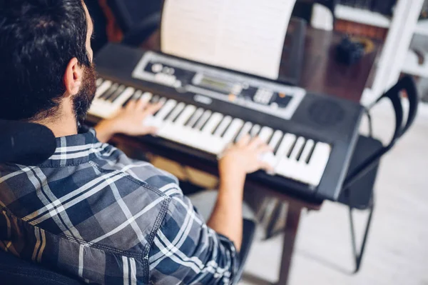 Amateur pianist playing the piano at home.Enjoying the music