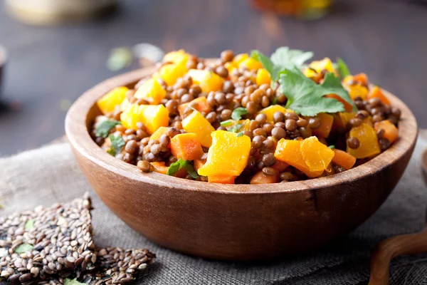 Lentil with carrot and pumpkin ragout in a wooden bowl. — Stock Image Lentil with carrot and pumpkin ragout in a wooden bowl. Stock Picture