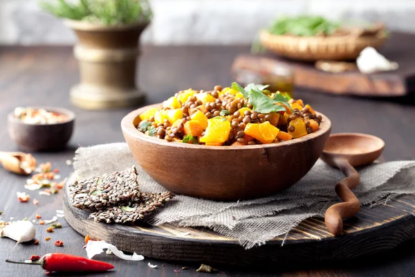 Lentil with carrot and pumpkin ragout in a wooden bowl. — Stock Image Lentil with carrot and pumpkin ragout in a wooden bowl. Royalty Free Stock Images