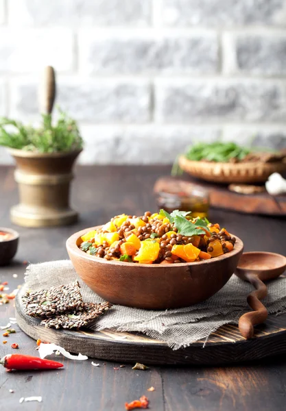 Lentil with carrot and pumpkin ragout in a wooden bowl. — Stock Image Lentil with carrot and pumpkin ragout in a wooden bowl. Stock Picture