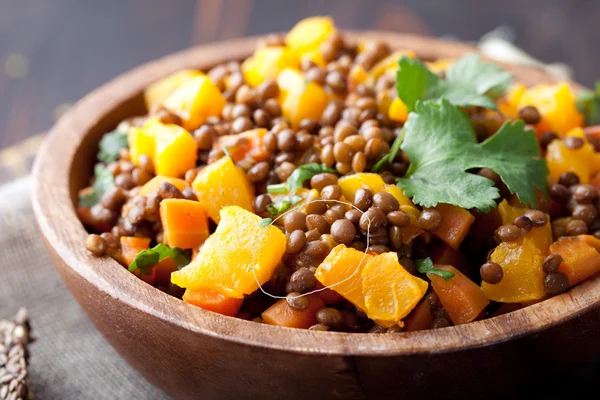 Lentil with carrot and pumpkin ragout in a wooden bowl. — Stock Image Lentil with carrot and pumpkin ragout in a wooden bowl. Stock Image