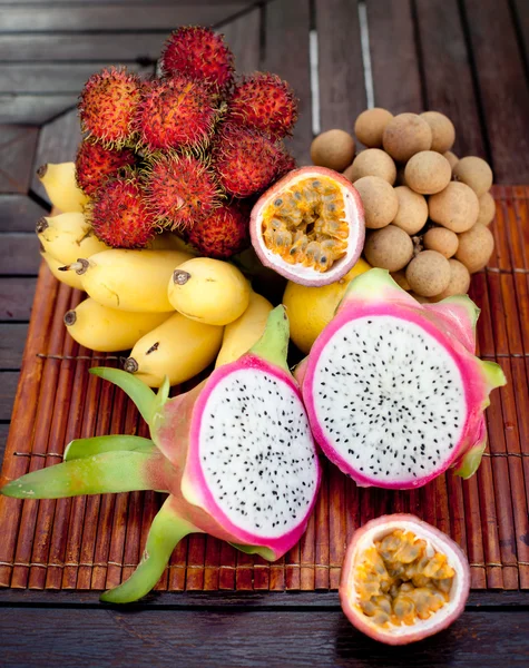 Assortment of tropical exotic fruits: dragonfruit, bananas, passion , longan, rambutan