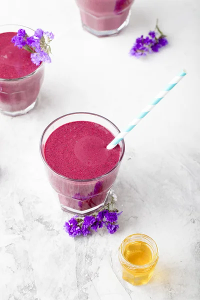 Blueberry, blackberry, honeysuckle, honeyberry smoothie with violet syrup and acai.