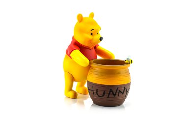 Figure of Winnie the Pooh and hunny pot. clipart