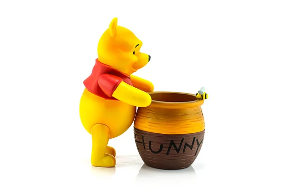 Figure of Winnie the Pooh and hunny pot. — Stock Photo, Image