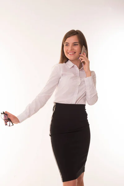 Girl speaks on the phone and smiles. — Stock Photo, Image